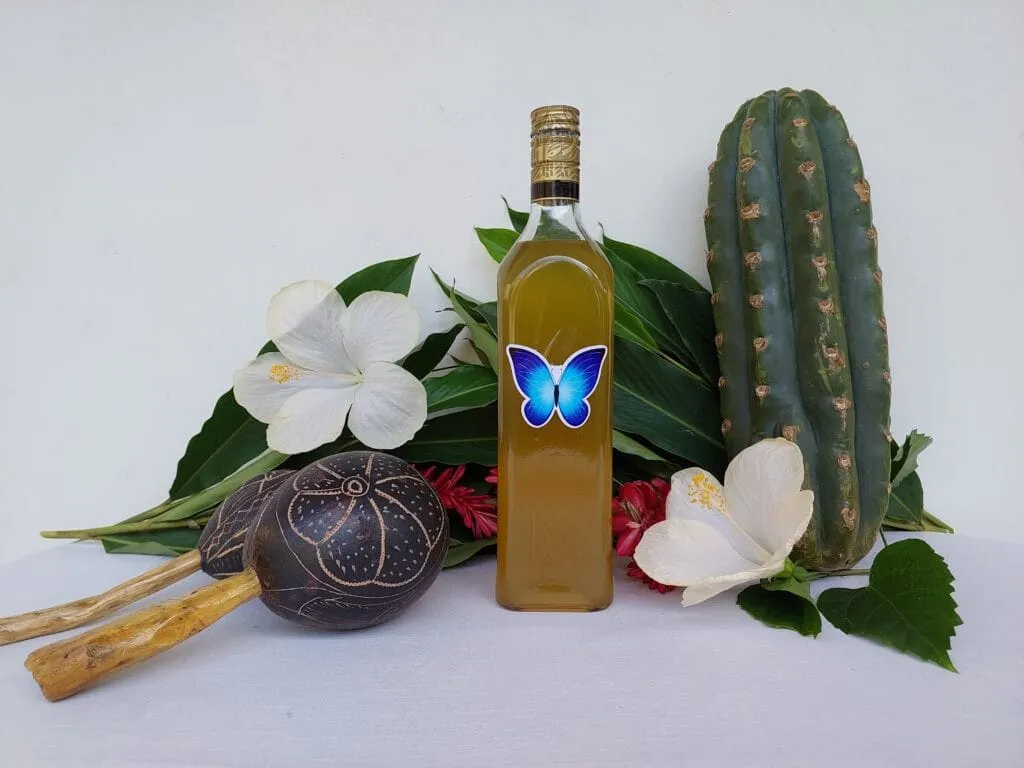 Blue Morpho ceremonial plant medicine bottle with tropical flowers and cactus display